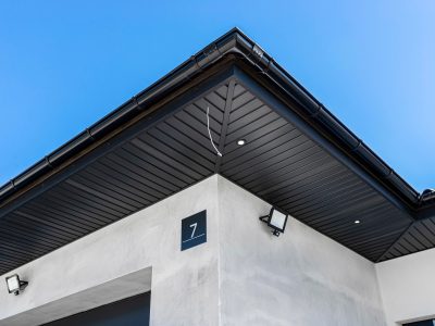 A modern graphite herringbone roof lining is attached to the trusses, visible turned on LED lights.
